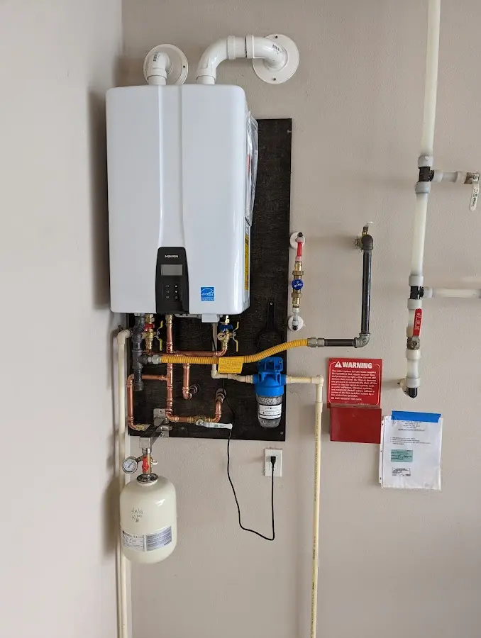 Professional plumber installing copper piping in a Oceano home